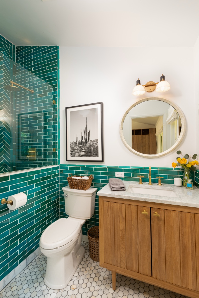 Luxury bathroom remodel with teal tile and custom vanity by Houston Construction